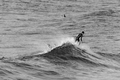 Close-up of man surfing on waves in sea