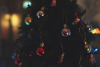 Christmas decoration hanging on tree at night