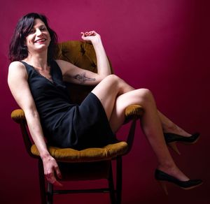 Portrait of young woman sitting on chair