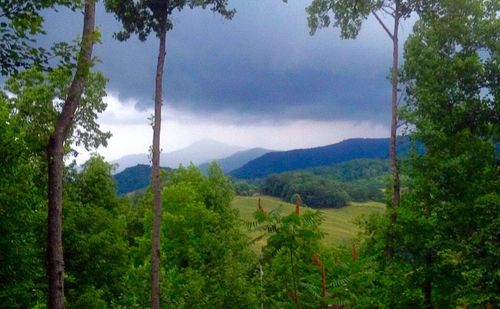 Scenic view of mountains against cloudy sky