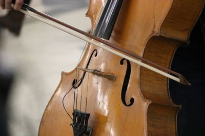 Close-up of playing cello on the subway station in canada.