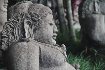 Close-up of statue against stone wall