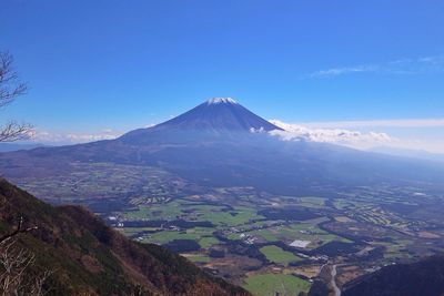 Aerial view of volcanic landscape against blue sky