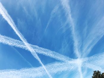 Low angle view of vapor trail against blue sky