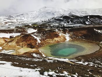 Frozen lake against mountain
