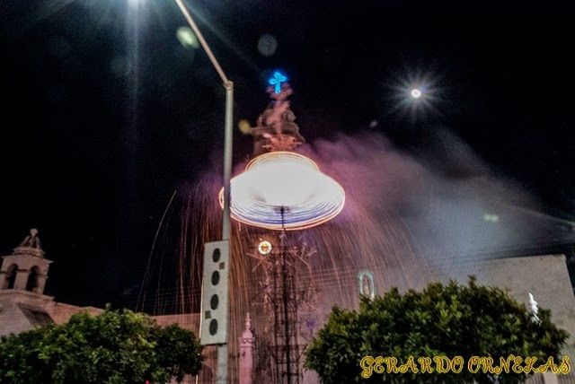 illuminated, night, architecture, built structure, lighting equipment, building exterior, street light, low angle view, religion, church, electricity, electric light, tree, sky, city, place of worship, travel destinations, glowing, outdoors