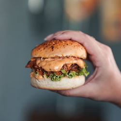 Close-up of hand holding burger