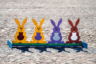 Easter holidays, games for children in the town square, wooden bunny figures for throwing rings