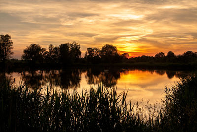 Scenic view of lake against sky during sunset