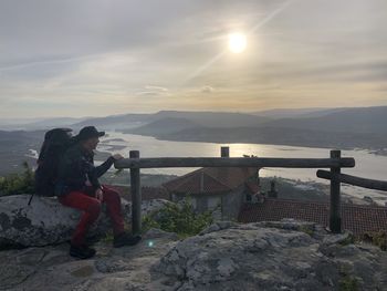 Man looking at sea against sky during winter