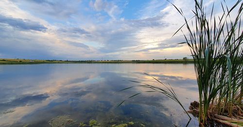 Scenic view of lake against sky during sunset