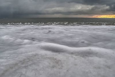 Scenic view of frozen sea during sunset