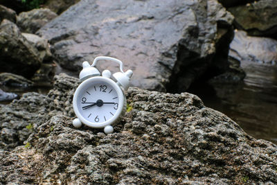 Close-up of clock on rock
