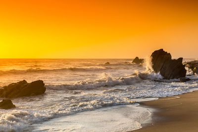 Scenic view of sea against clear sky during sunset