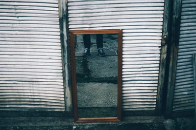 Man seen through blinds