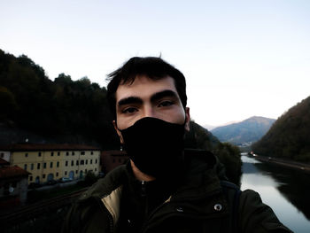 Portrait of young man against sky