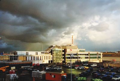 Buildings against cloudy sky