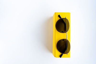 Close-up of yellow umbrella against white background