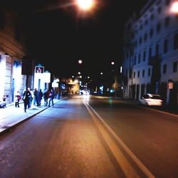 Illuminated city street at night