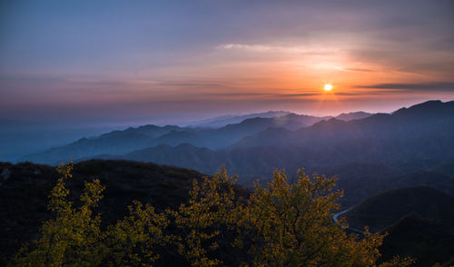Scenic view of mountains against sky during sunset