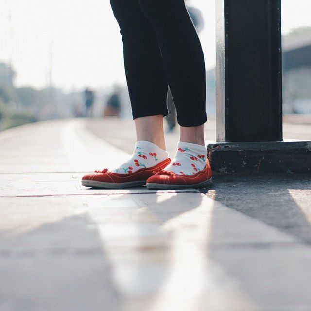 low section, person, shoe, lifestyles, standing, street, selective focus, footwear, leisure activity, men, focus on foreground, walking, casual clothing, human foot, fashion, day