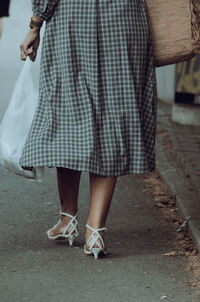 Low section of women standing on street