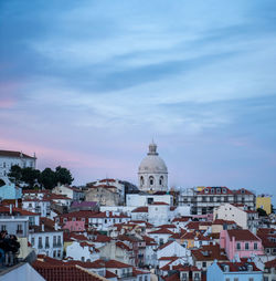 High angle view of buildings in city against cloudy sky taken in lisbon, portugal