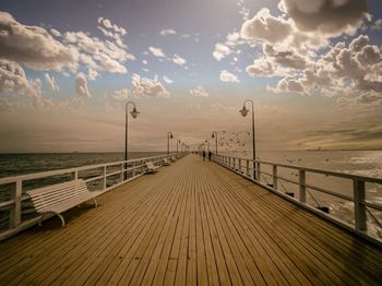 Pier over sea against sky