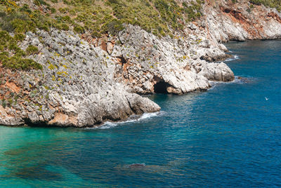 High angle view of rocks on sea shore