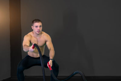 Portrait of young woman exercising in gym