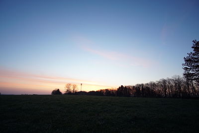 Scenic view of field against sky during sunset