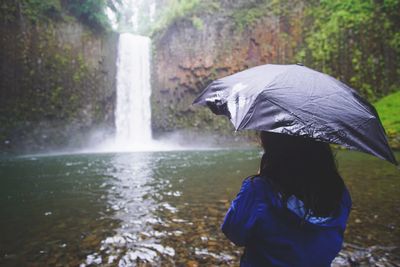 Rear view of man with umbrella