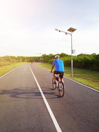 Man riding bicycle on road