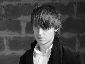 Close-up of young man against wall