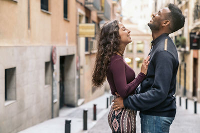 Side view of couple standing outdoors