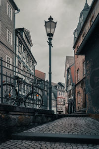 Low angle view of street and buildings against sky