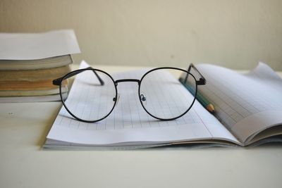 Close-up of eyeglasses on book