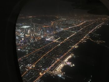 High angle view of illuminated city buildings at night