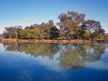 Reflection of trees in lake against sky