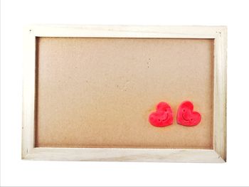 Close-up of red rose on paper