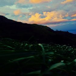 Scenic view of mountains against cloudy sky
