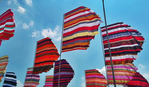 Low angle view of flags against sky