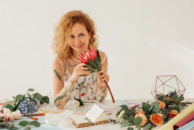 Portrait of a smiling young woman holding flower