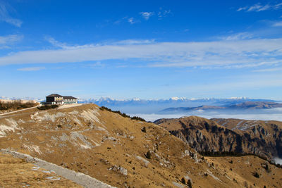 Scenic view of landscape and mountains against blue sky