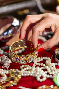 Cropped hand of woman touching jewelry