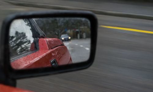 Reflection of car in side-view mirror