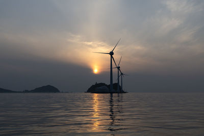 Sailboat on sea against sky during sunset
