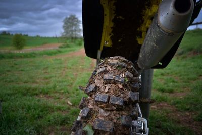 Close-up of motocross parked on field