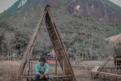 Portrait of man standing on land against mountain