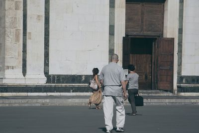 Full length of woman standing by railing